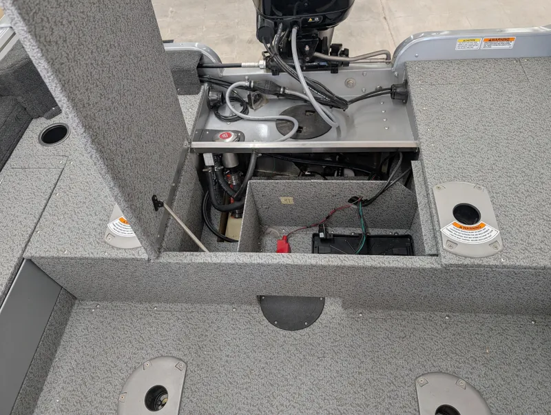 Slide: The Image of 2023 Starcraft Stealth 16 SC boat interior, showcasing storage compartments and engine area. - 9