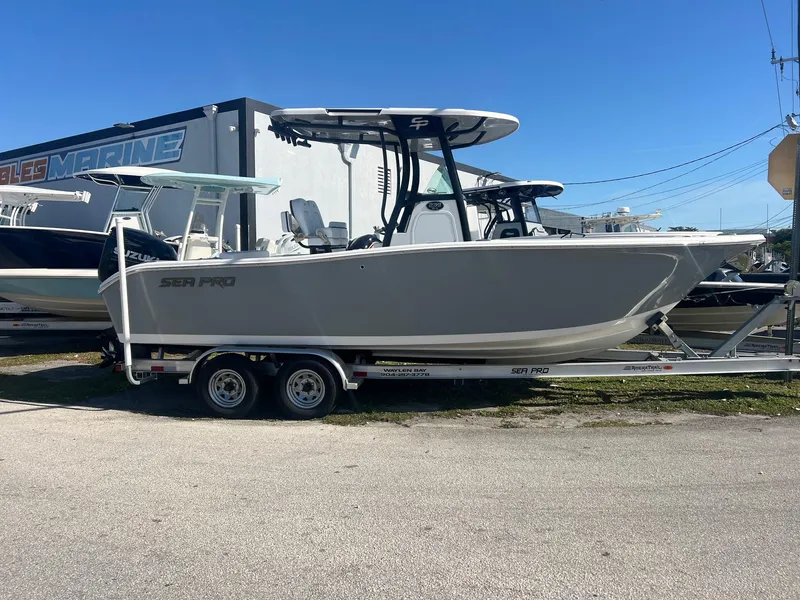 The Image of 2024 Sea Pro 242 DLX boat on trailer, parked outdoors. - 1