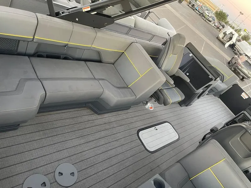 Slide: The Image of 2024 Manitou Explorer 24 interior with gray seating and modern design. - 11