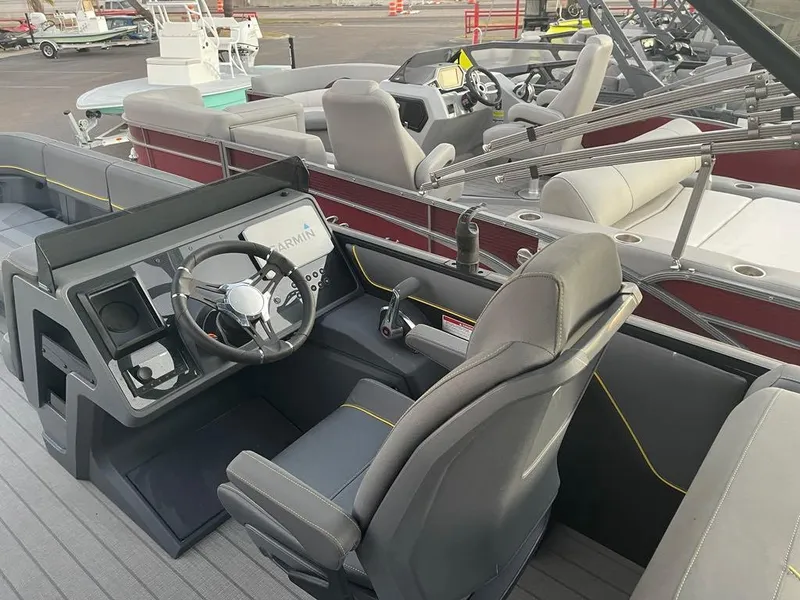 Slide: The Image of 2024 Manitou Explorer 24 boat interior with modern steering and seating. - 12