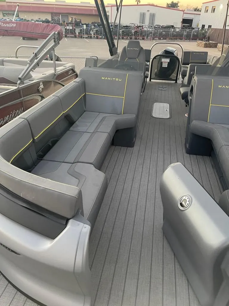 Slide: The Image of 2024 Manitou Explorer 24 pontoon boat with spacious seating and modern design. - 14