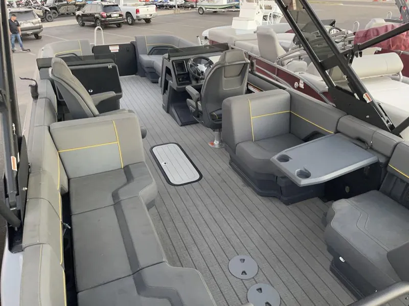 Slide: The Image of 2024 Manitou Explorer 24 pontoon boat interior with spacious seating and modern design. - 7