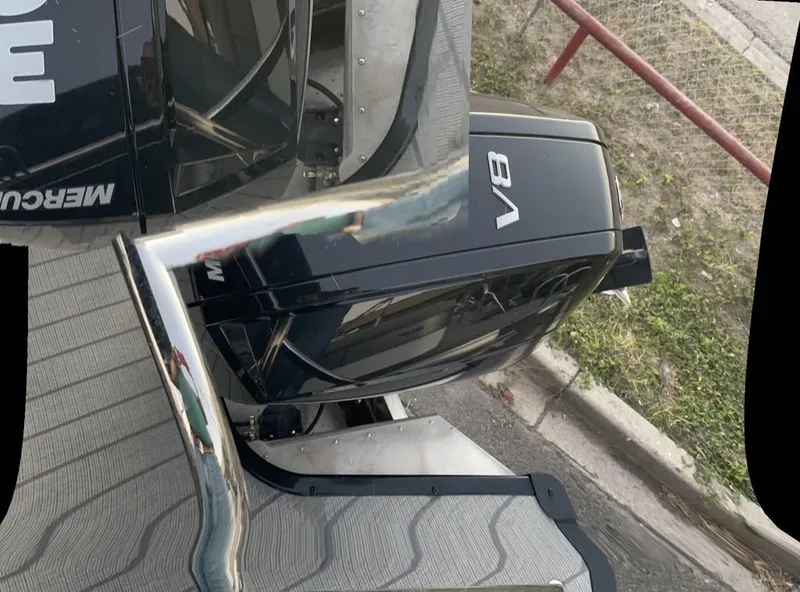 Slide: The Image of 2024 Manitou Explorer 24 with V8 Mercury engine, docked on a sunny day. - 8