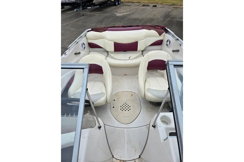 Slide: The Image of 2009 Tahoe Q4 SS boat interior with white and maroon seating arrangement. - 22