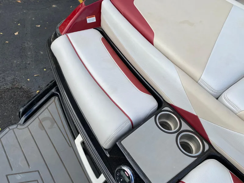 Slide: The Image of 2016 Malibu Wakesetter 23 LSV boat interior with red and white seating and cup holders. - 10
