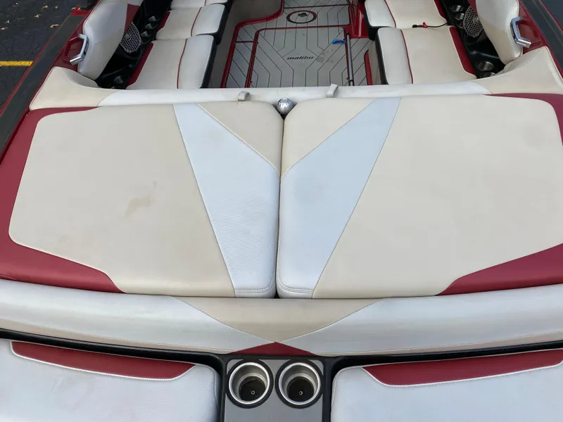 Slide: The Image of 2016 Malibu Wakesetter 23 LSV boat interior with red and white seating. - 11