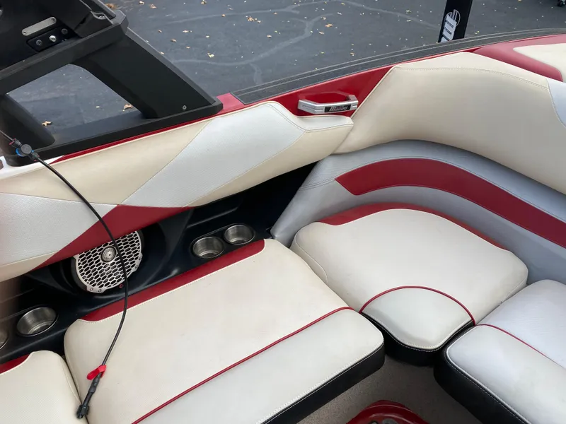 Slide: The Image of 2016 Malibu Wakesetter 23 LSV interior with red and white seating and speaker system. - 17