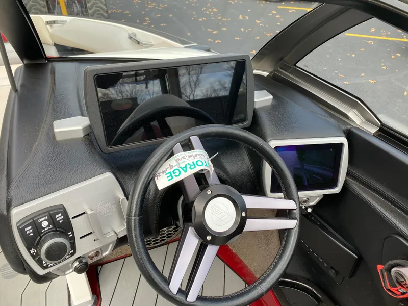Slide: The Image of 2016 Malibu Wakesetter 23 LSV dashboard with steering wheel and digital displays. - 19
