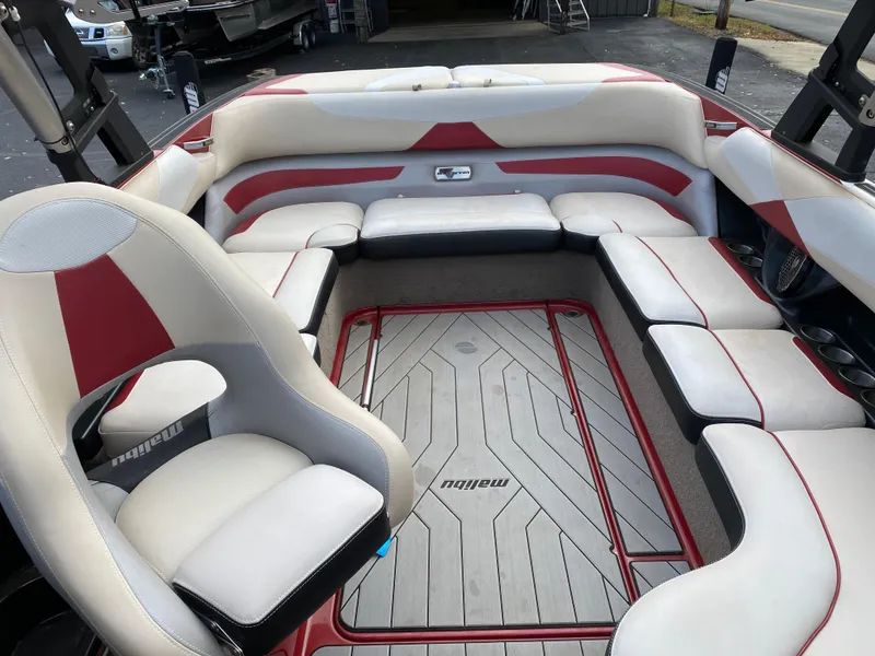 Slide: The Image of 2016 Malibu Wakesetter 23 LSV interior with white and red seating, spacious layout. - 23