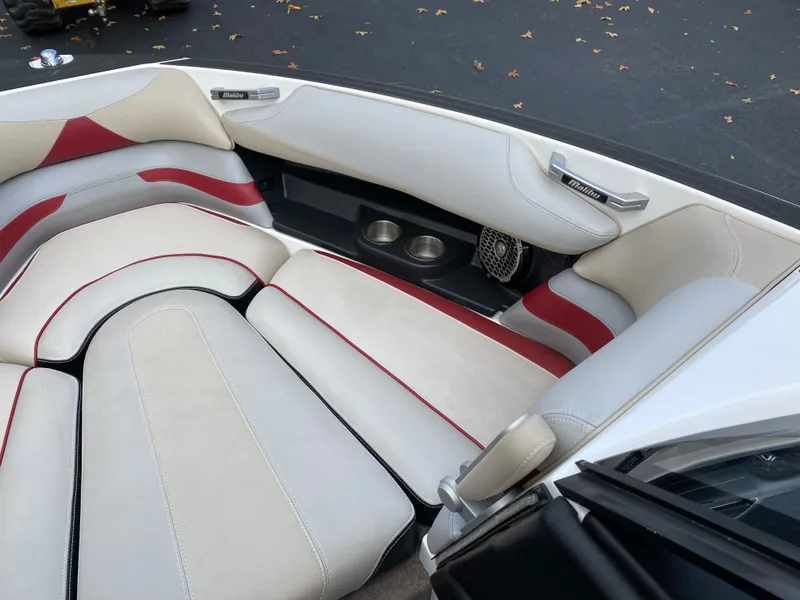 Slide: The Image of 2016 Malibu Wakesetter 23 LSV interior with white and red cushioned seating. - 26