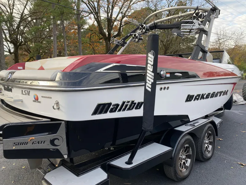 Slide: The Image of 2016 Malibu Wakesetter 23 LSV boat on trailer, red and white design. - 3