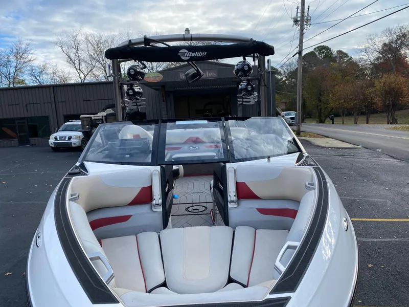 Slide: The Image of 2016 Malibu Wakesetter 23 LSV boat with open bow seating, parked outdoors. - 4
