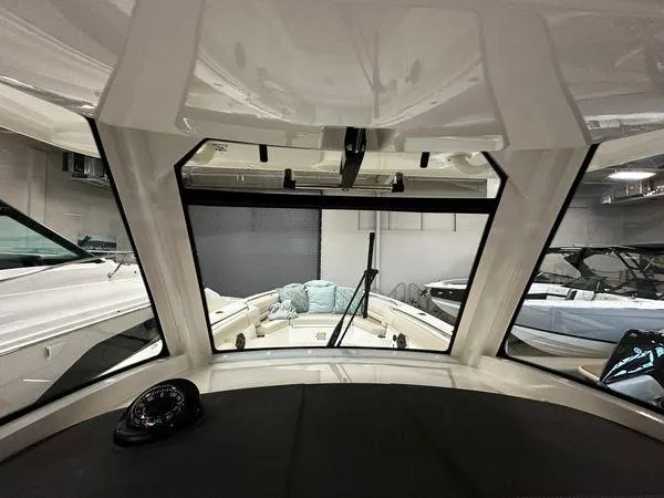 Slide: The Image of Interior view of 2022 Boston Whaler 330 Outrage boat, showcasing cockpit and windshield. - 15