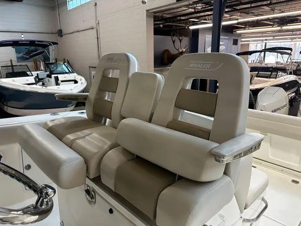 Slide: The Image of 2022 Boston Whaler 330 Outrage boat seats in showroom setting. - 18