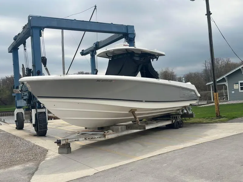 Slide: The Image of 2022 Boston Whaler 330 Outrage on a boat lift, ready for launch. - 2
