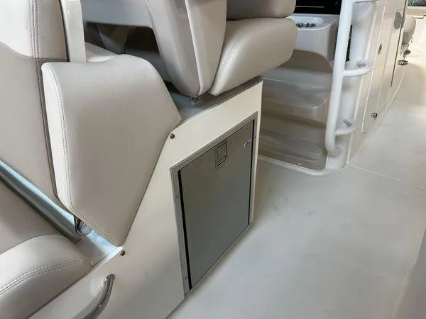 Slide: The Image of 2022 Boston Whaler 330 Outrage interior seating and storage compartment. - 21