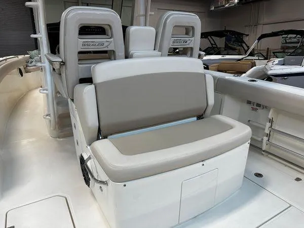 Slide: The Image of 2022 Boston Whaler 330 Outrage boat interior with cushioned seating. - 23