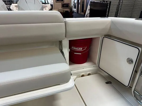 Slide: The Image of 2022 Boston Whaler 330 Outrage interior with seating and storage compartment. - 25