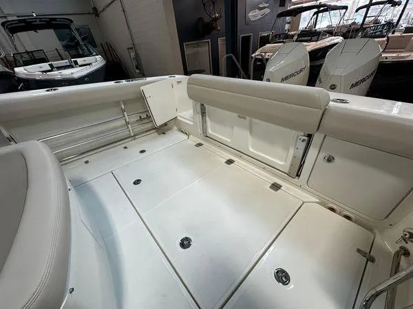 Slide: The Image of 2022 Boston Whaler 330 Outrage boat interior with seating and storage compartments. - 27