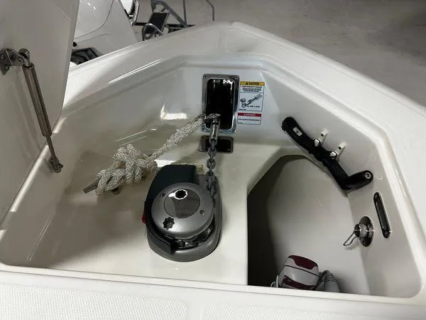 Slide: The Image of Anchor compartment of 2022 Boston Whaler 330 Outrage boat, featuring rope and winch. - 6