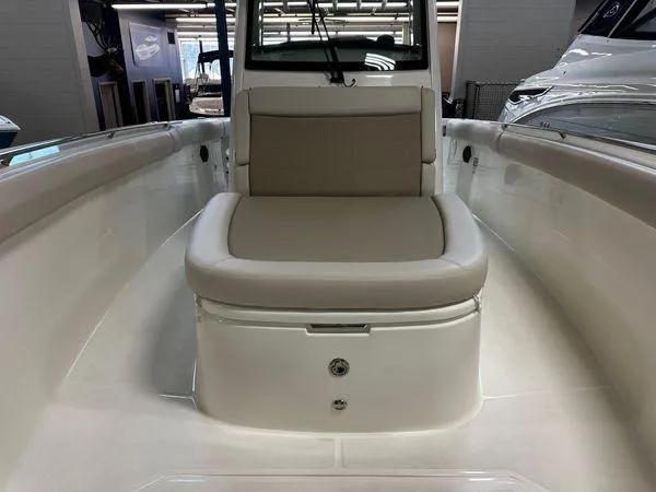 Slide: The Image of 2022 Boston Whaler 330 Outrage boat interior with cushioned seating. - 9