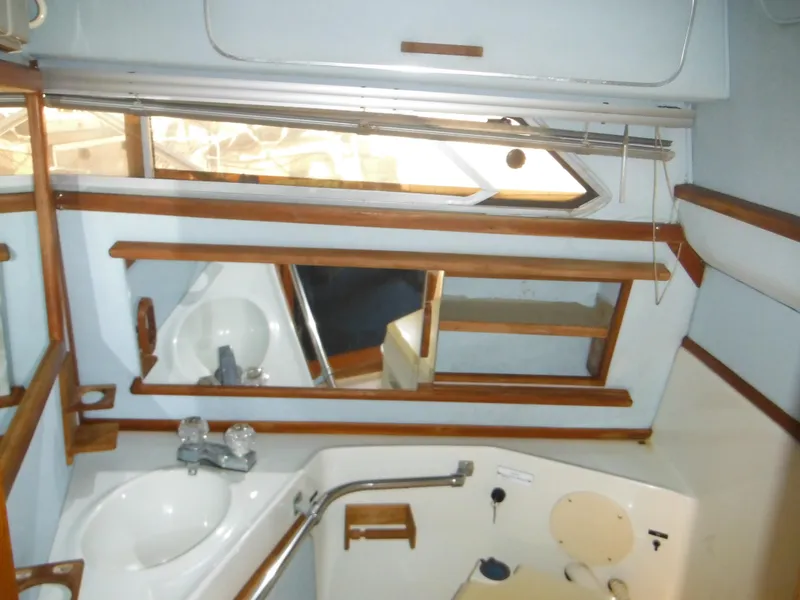 Slide: The Image of Interior of 1988 Sea Ray 270 Sundancer boat bathroom with sink and mirror. - 12