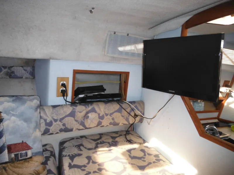 Slide: The Image of Interior of 1988 Sea Ray 270 Sundancer with TV and floral seating. - 14