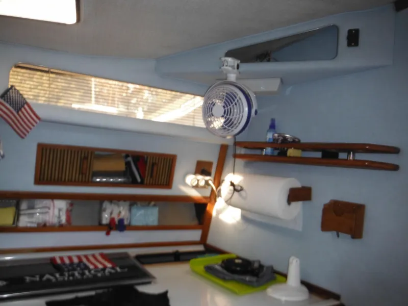 Slide: The Image of Interior of 1988 Sea Ray 270 Sundancer boat with shelves and fan. - 18