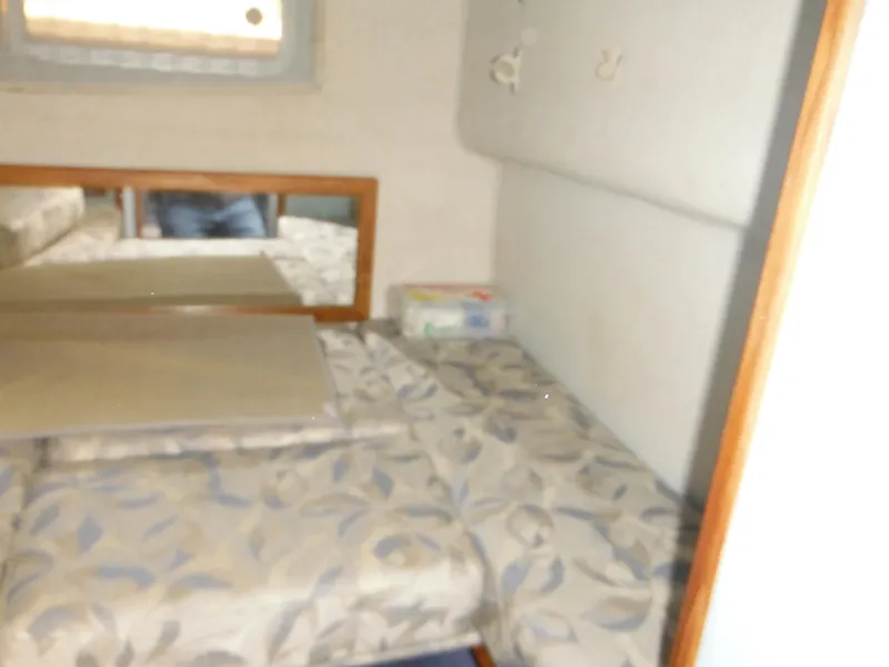 Slide: The Image of Interior cabin of 1988 Sea Ray 270 Sundancer with floral-patterned bedding. - 19