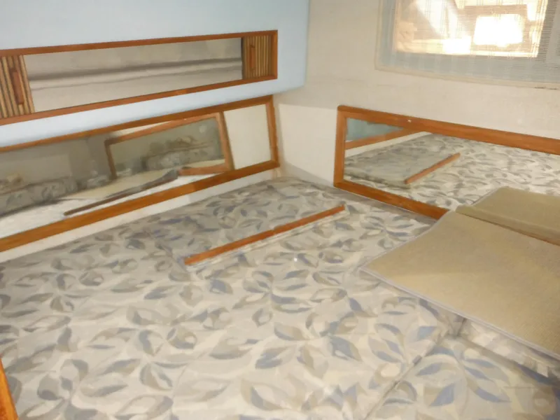 Slide: The Image of Interior cabin of 1988 Sea Ray 270 Sundancer with patterned bedding and mirrors. - 20