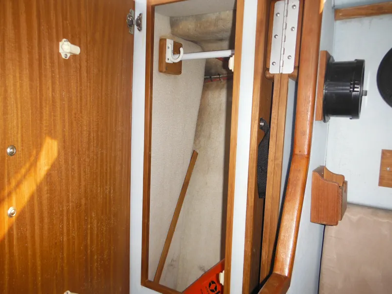Slide: The Image of Interior closet of 1988 Sea Ray 270 Sundancer boat with wooden finish. - 21