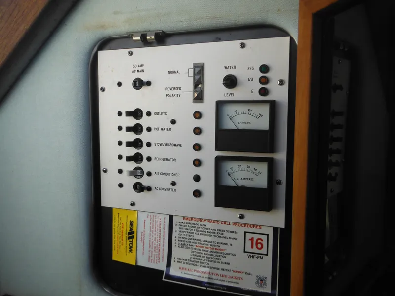 Slide: The Image of Control panel of a 1988 Sea Ray 270 Sundancer boat with gauges and switches. - 22