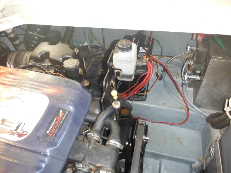 Slide: The Image of Engine compartment of 1988 Sea Ray 270 Sundancer boat, showing mechanical components and wiring. - 28