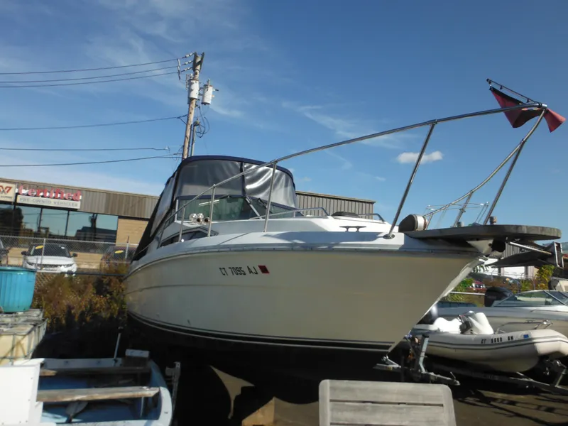 Slide: The Image of 1988 Sea Ray 270 Sundancer boat on display in a marina setting. - 3