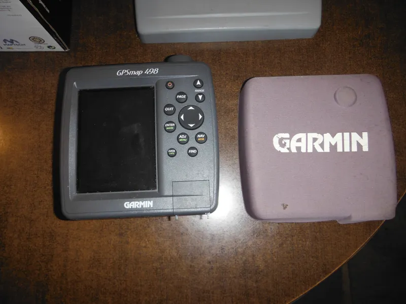 Slide: The Image of Garmin GPSmap 498 device with protective case on a wooden surface. - 35
