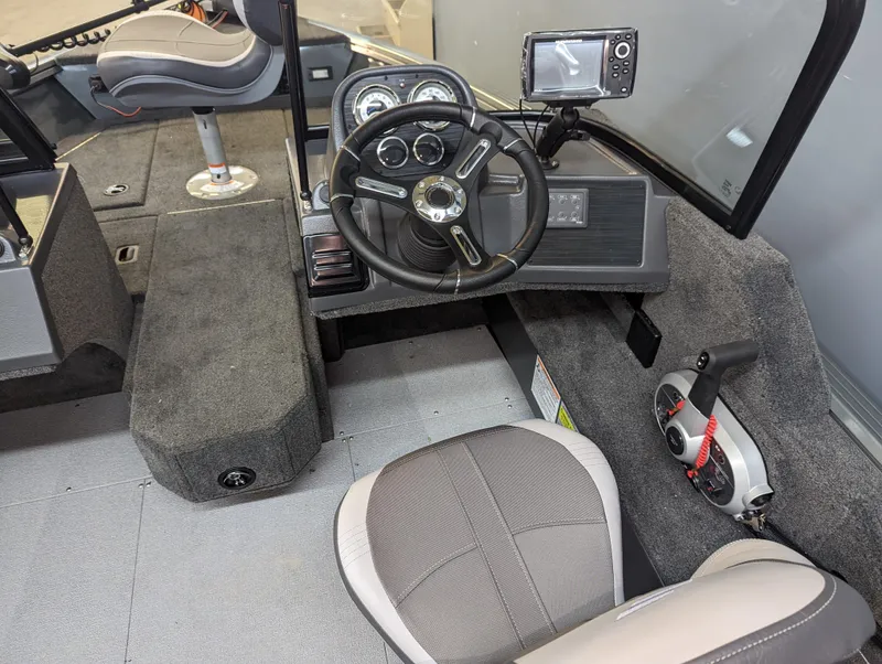 Slide: The Image of 2023 Starcraft Storm 166 DC Pro boat interior with steering wheel and navigation system. - 4