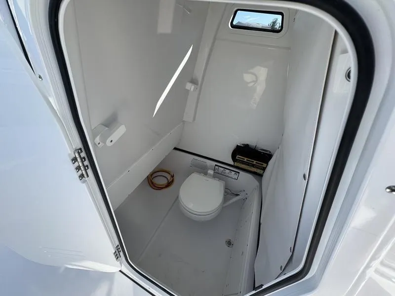 Slide: The Image of 2025 Sportsman Open 252 boat interior with compact marine toilet. - 15