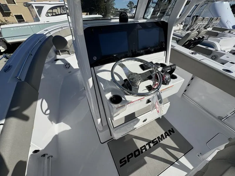 Slide: The Image of 2025 Sportsman Open 252 boat cockpit with modern steering and dual screens. - 17