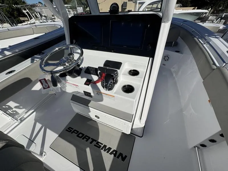 Slide: The Image of 2025 Sportsman Open 252 boat cockpit with steering wheel and control panel. - 18