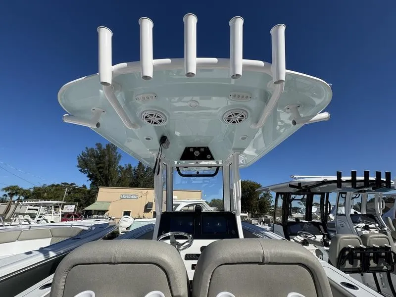 Slide: The Image of 2025 Sportsman Open 252 boat interior with rod holders and seating. - 27