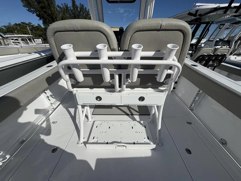 Slide: The Image of 2025 Sportsman Open 252 boat interior with rod holders and seating. - 28