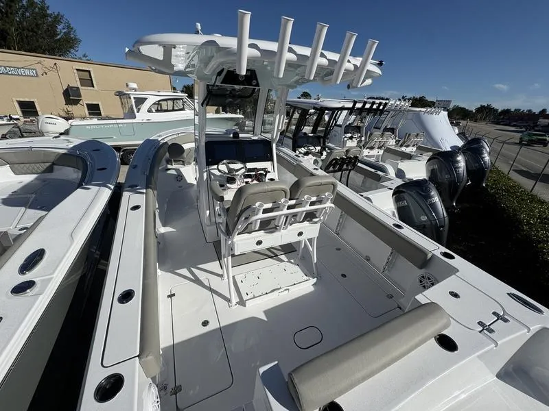 Slide: The Image of 2025 Sportsman Open 252 boat with dual seats and modern console in a showroom. - 29