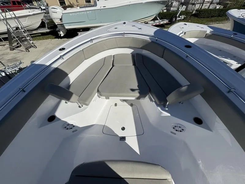 Slide: The Image of 2025 Sportsman Open 252 boat interior with cushioned seating and storage compartments. - 6