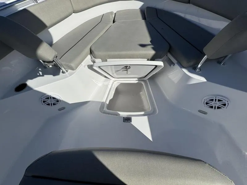 Slide: The Image of 2025 Sportsman Open 252 boat interior with cushioned seating and storage compartment. - 7