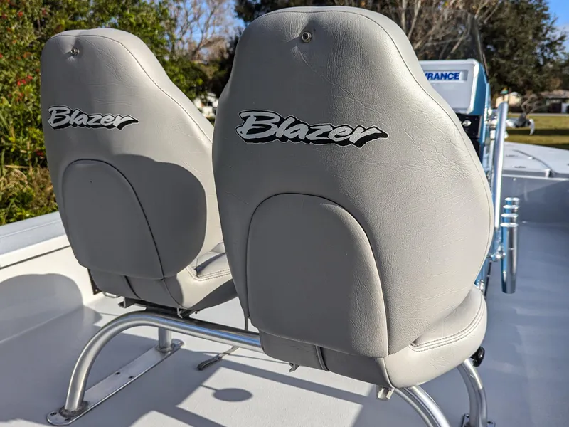 Slide: The Image of 2024 Blazer 675 Ultimate Bay boat seats with logo, outdoor setting. - 16