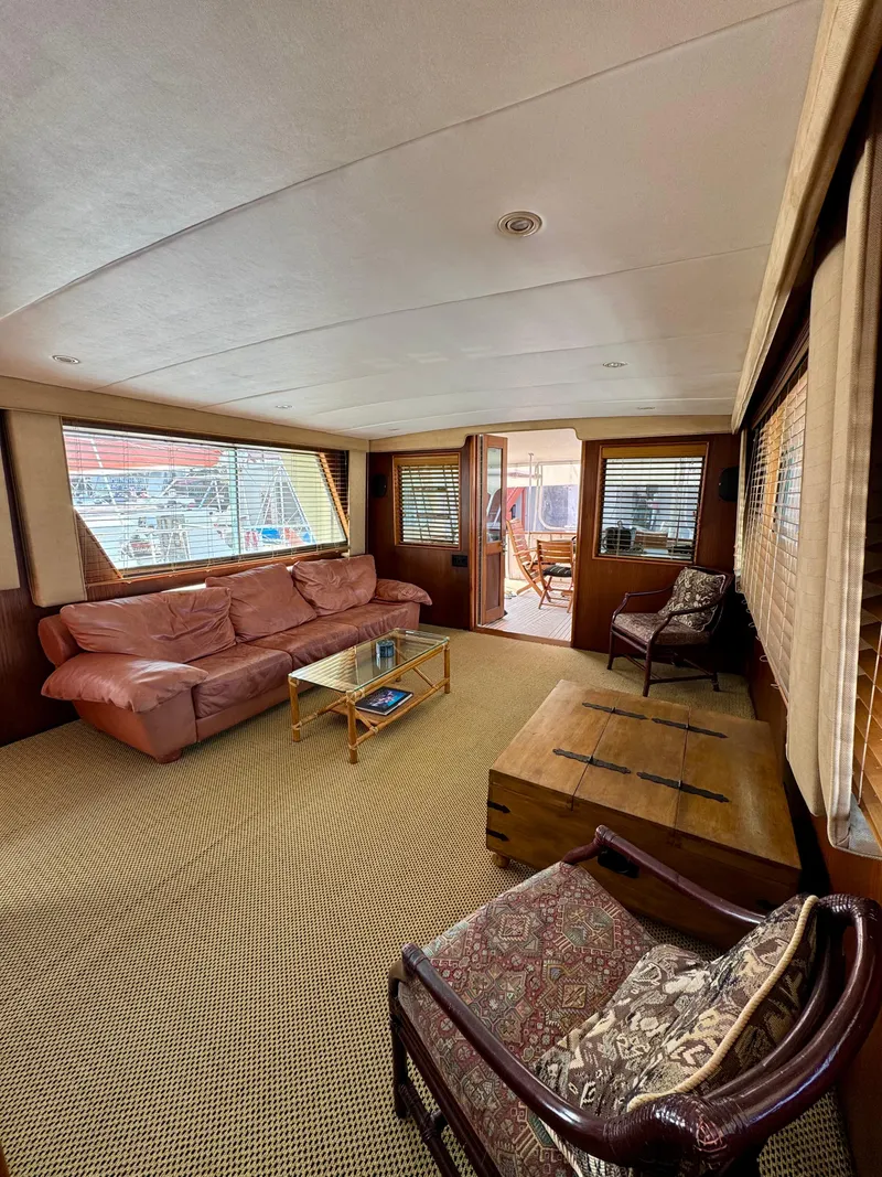 Slide: The Image of Interior of 1984 Hatteras Motor Yacht with cozy seating and wooden accents. - 10