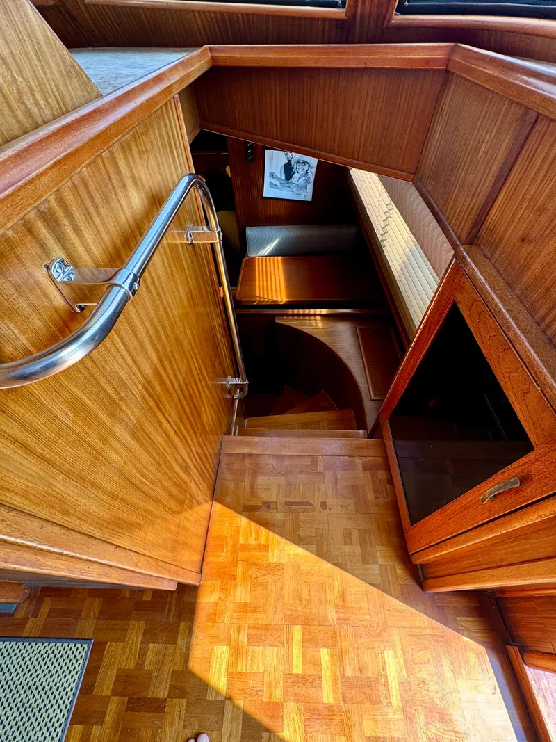 Slide: The Image of Interior of 1984 Hatteras Motor Yacht with wooden stairs and handrail. - 11