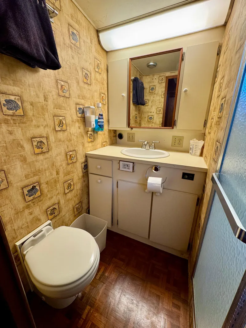 Slide: The Image of 1984 Hatteras Motor Yacht bathroom with vintage decor and compact design. - 13