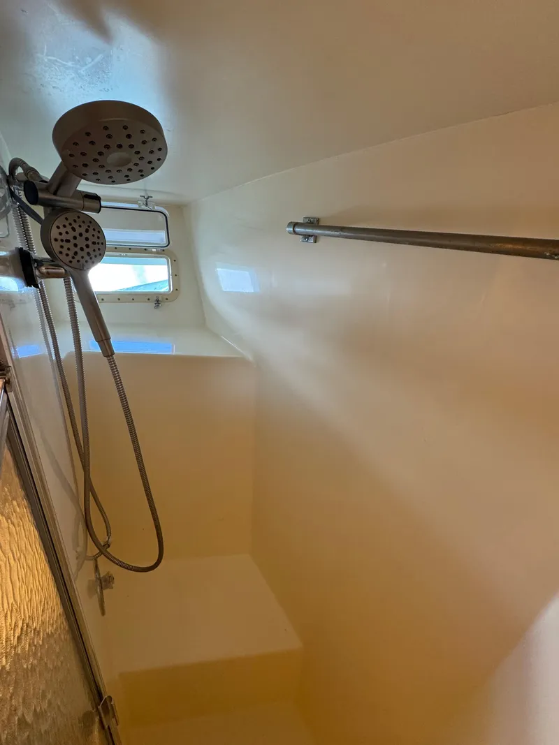 Slide: The Image of Shower area in 1984 Hatteras Motor Yacht with dual showerheads and window. - 14