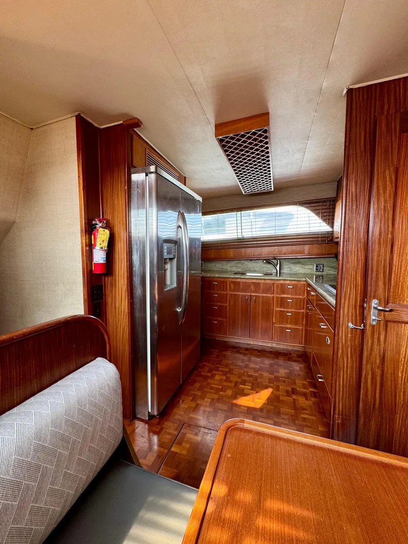 Slide: The Image of 1984 Hatteras Motor Yacht kitchen with wood cabinetry and stainless steel appliances. - 15